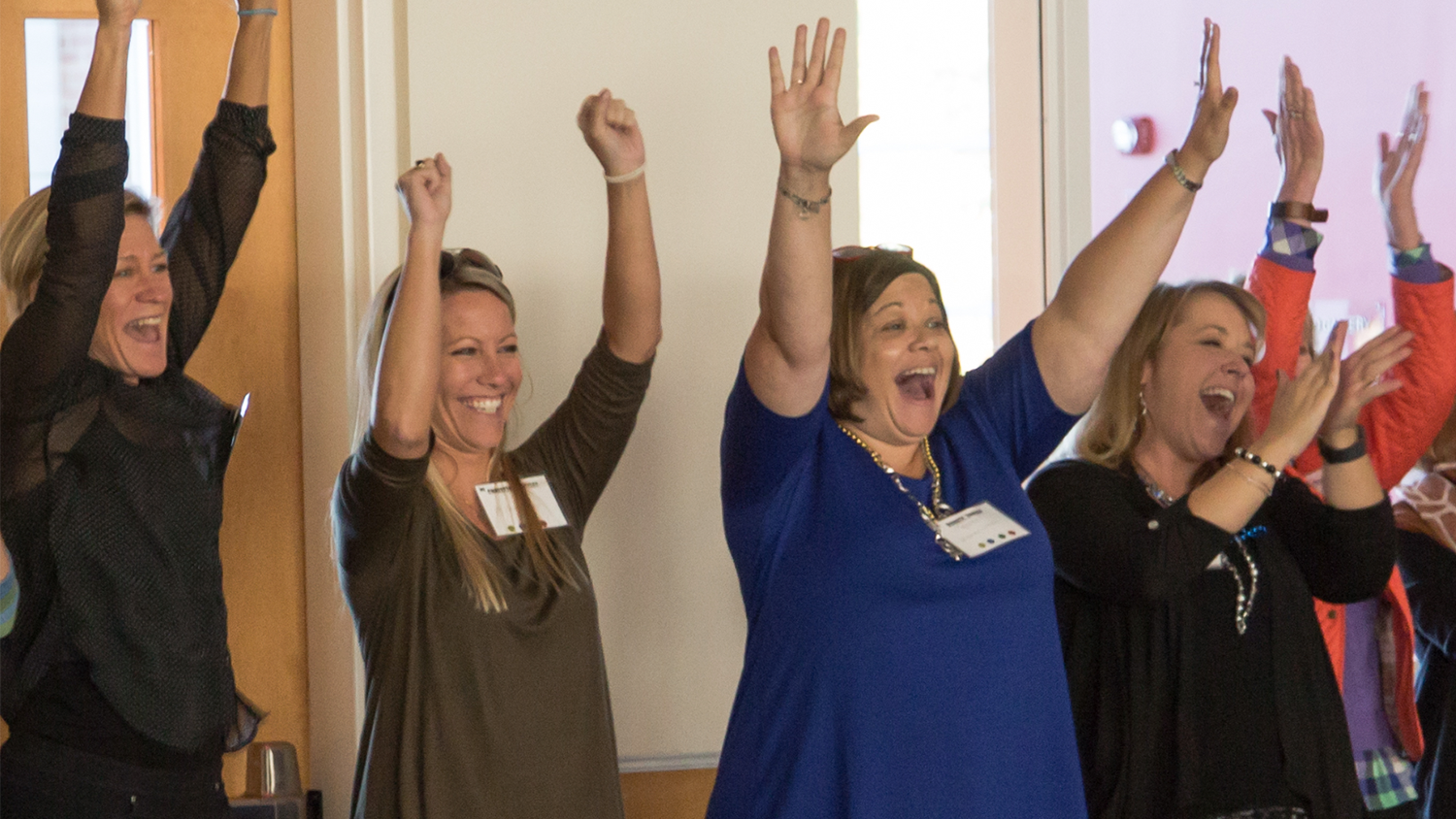 Educators cheer at a gathering of the North Carolina Digital Leaders Coaching Network.