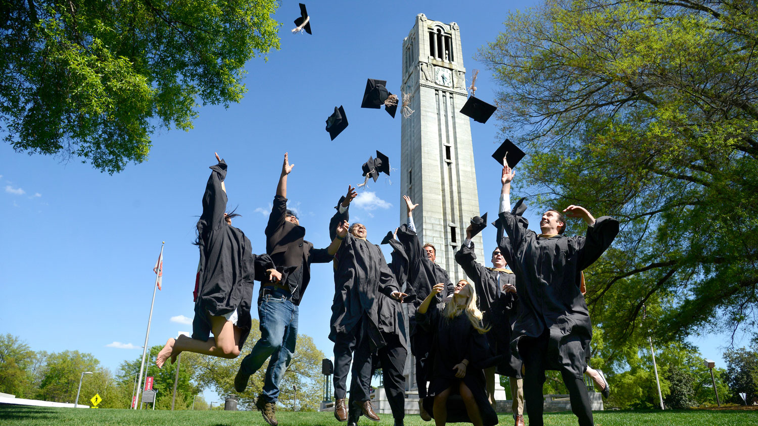 Graduating students in front of the Memorial Belltower.