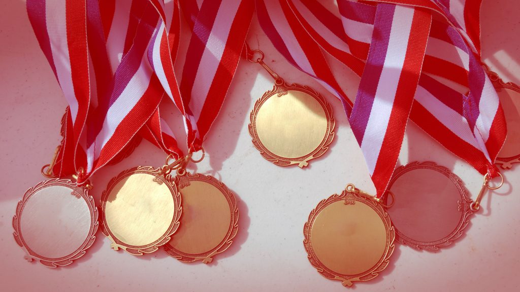 A photo of medals with a light red color overlay