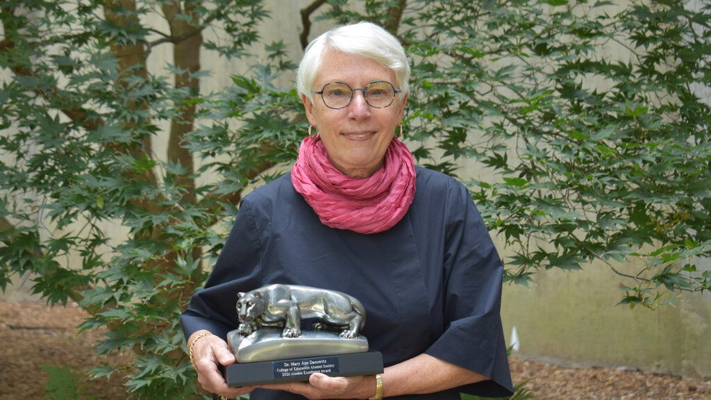 Mary Ann Danowitz holding Penn State College of Education's Alumni Excellence Award