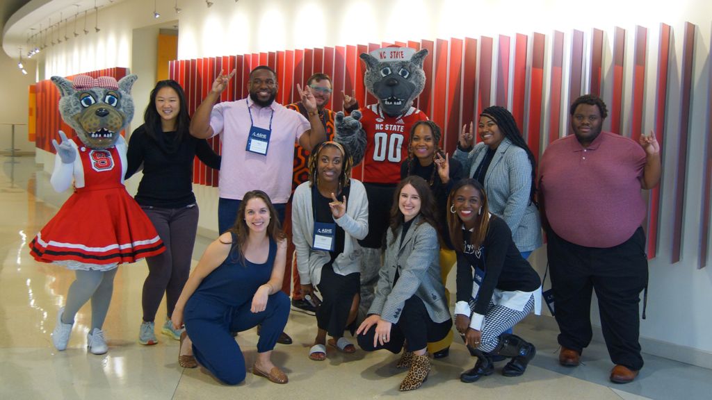 Alumni Distinguished Graduate Professor Joy Gaston Gayles and College of Education graduate students pose with Mr. and Mrs. Wuf at the Friday Institute during the ACPA/ASHE Presidential Symposium.