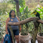 Ajaya Francis Jonas standing next to a toucan.