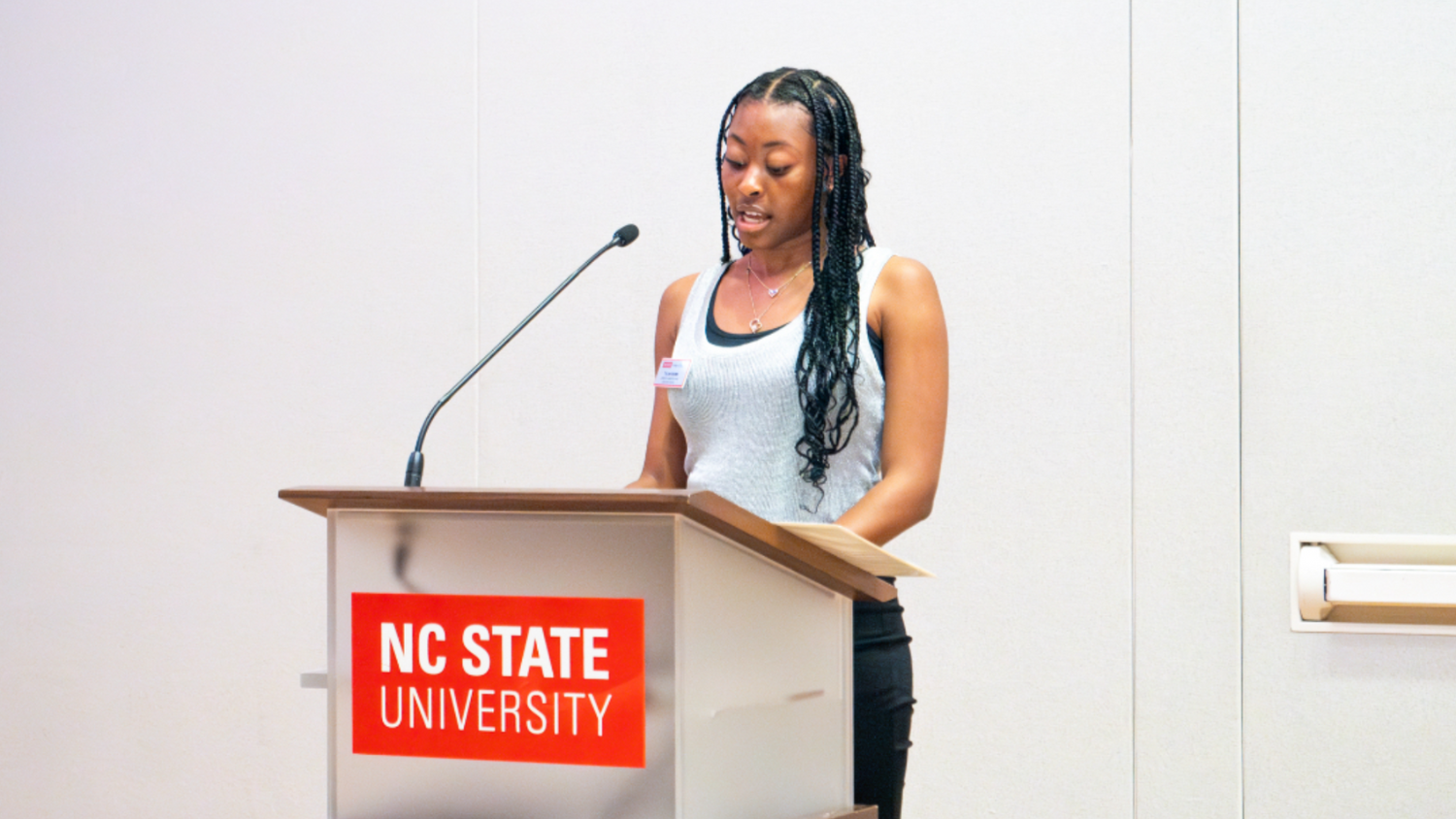 Tylan Deams standing at a lectern.