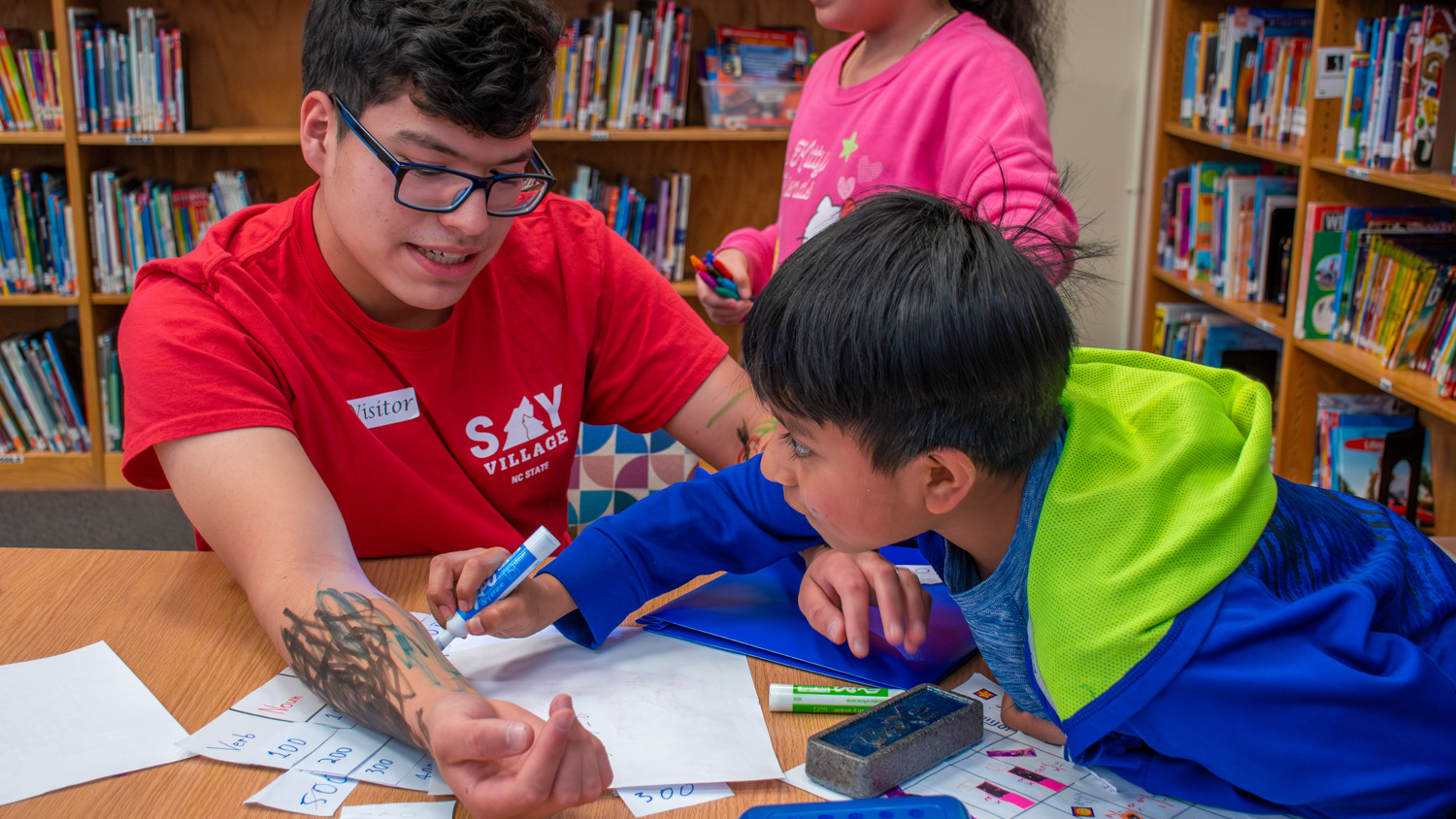 Gabriel Castillo Calderon work with a student at a SAY Village field placement.