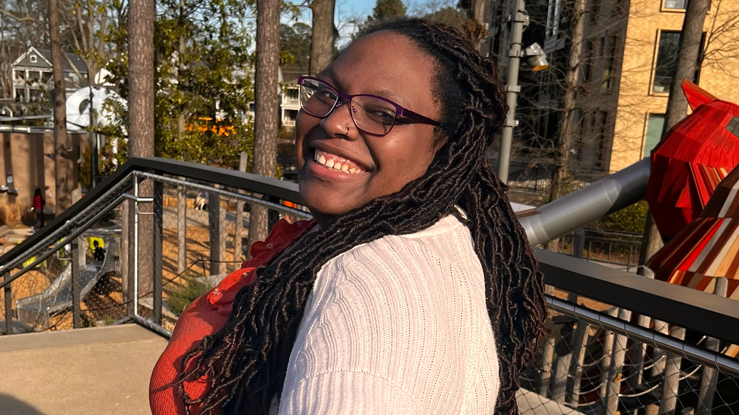 A photo of Calena Jones smiling into the camera at the Downtown Cary Park.