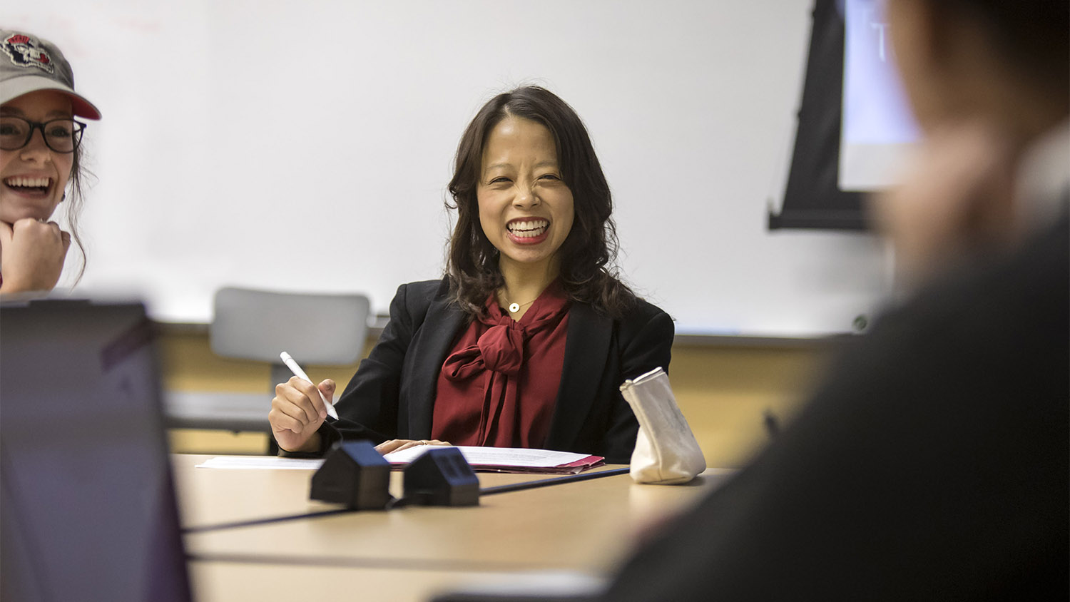 Dr. Crystal Chen Lee, professor smiling while teaching college of education students in classroom
