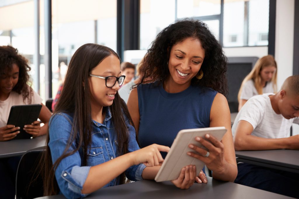Teacher and student looking at a tablet
