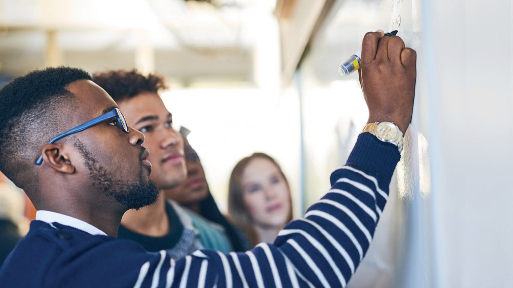 a photo of a teacher at a whiteboard
