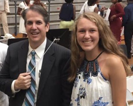 A photo of Emily Southard and her band teacher Mr. Kuni