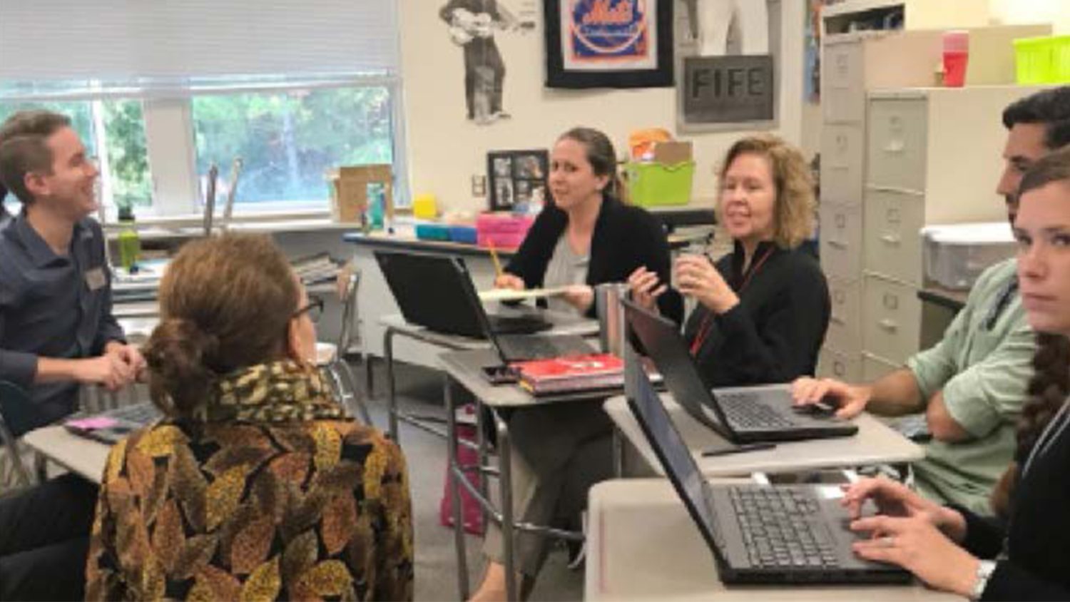Teachers in a classroom meeting