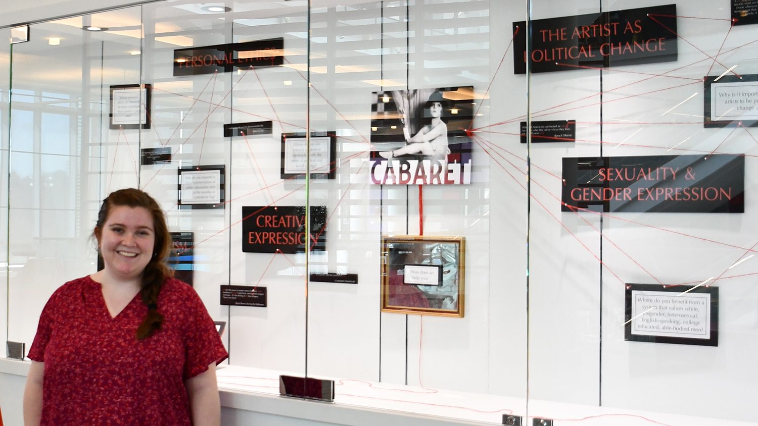 A photo of Erin Lisi by her Cabaret curriculum display