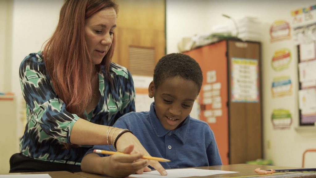 Teacher Helping a Student Read
