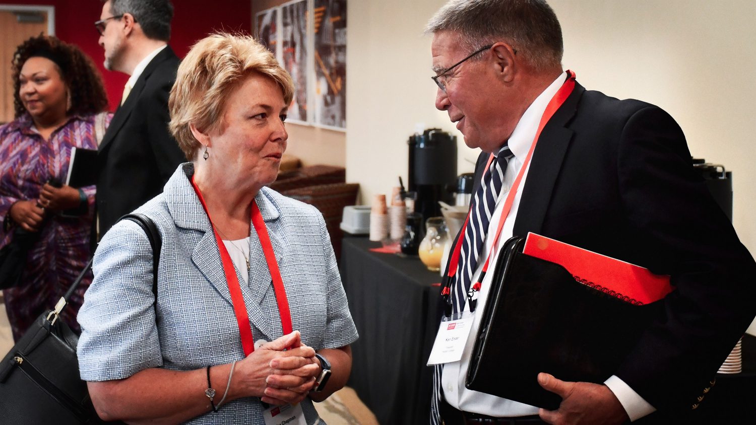 Two community college leaders talk during the statewide leadership conference on community college's impact on economic mobility.