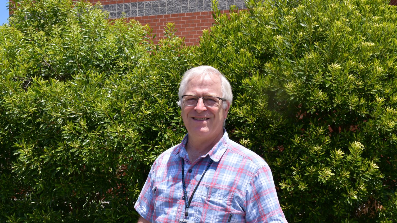 Joe Busby '99EDD stands outside his classroom at Panther Creek High School in Cary