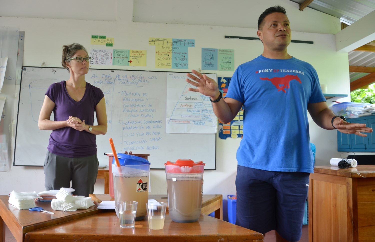 Assistant Professor KC Busch with a teacher as the perform a water filtration experiment in the Galapagos Islands