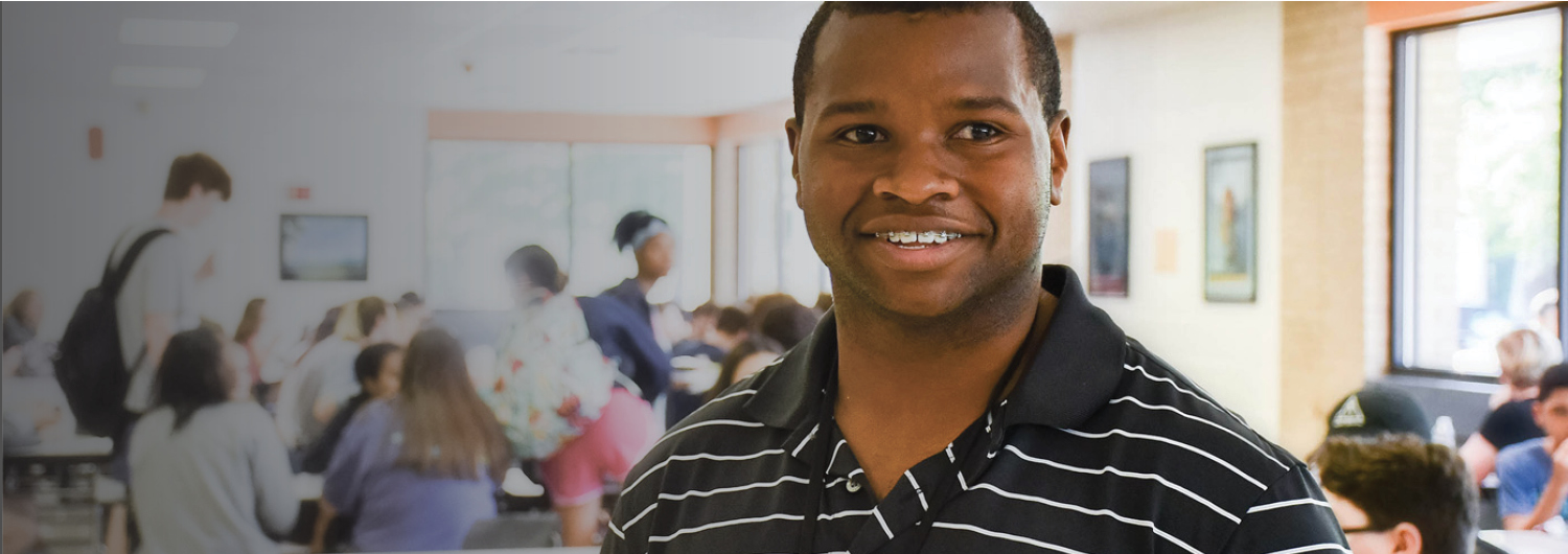 Student standing in classroom.