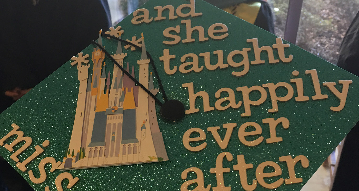 Graduation cap that says "And she taught happily ever after