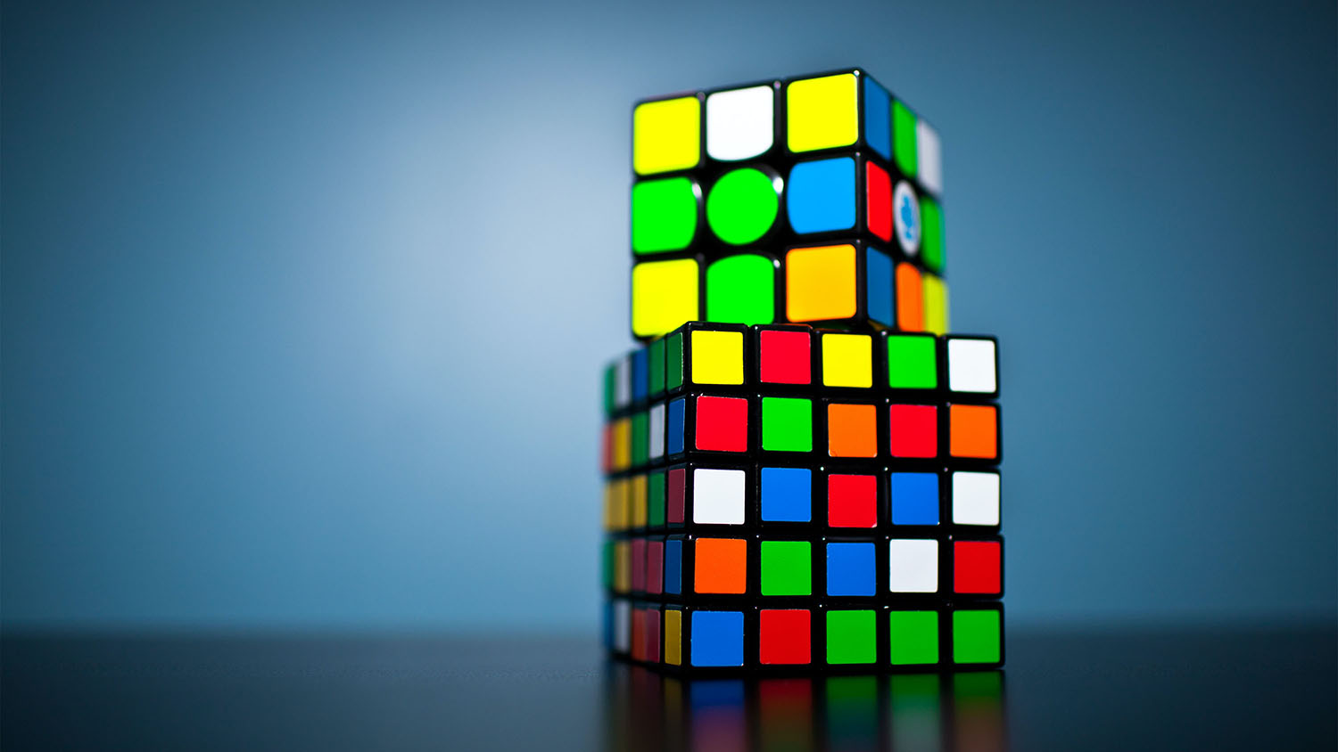 Two rubriks cubes stacked on top of each other