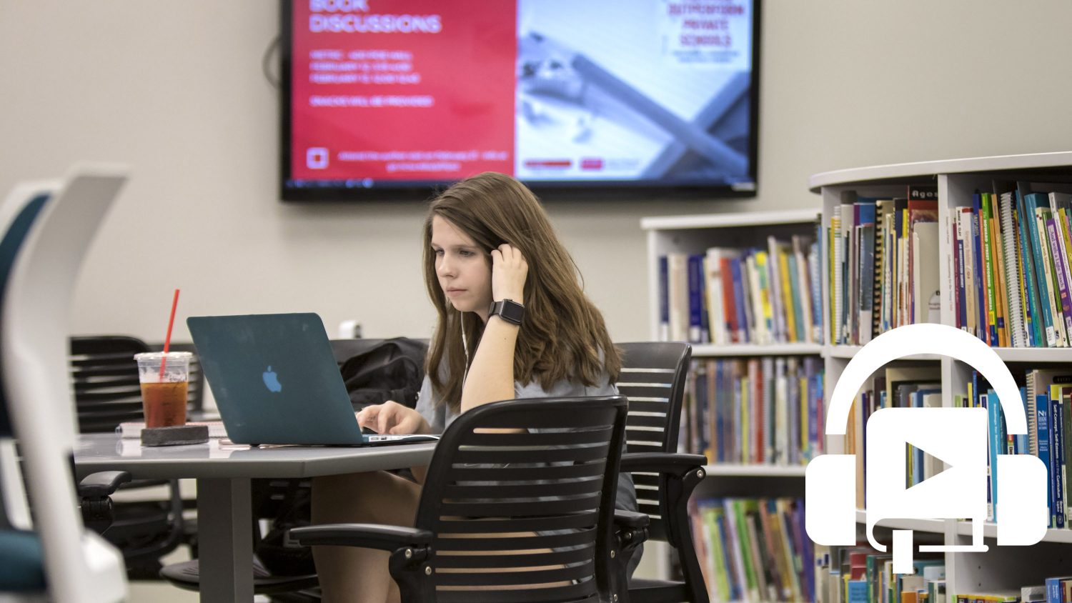 A student sitting in METRC listening to an audiobook