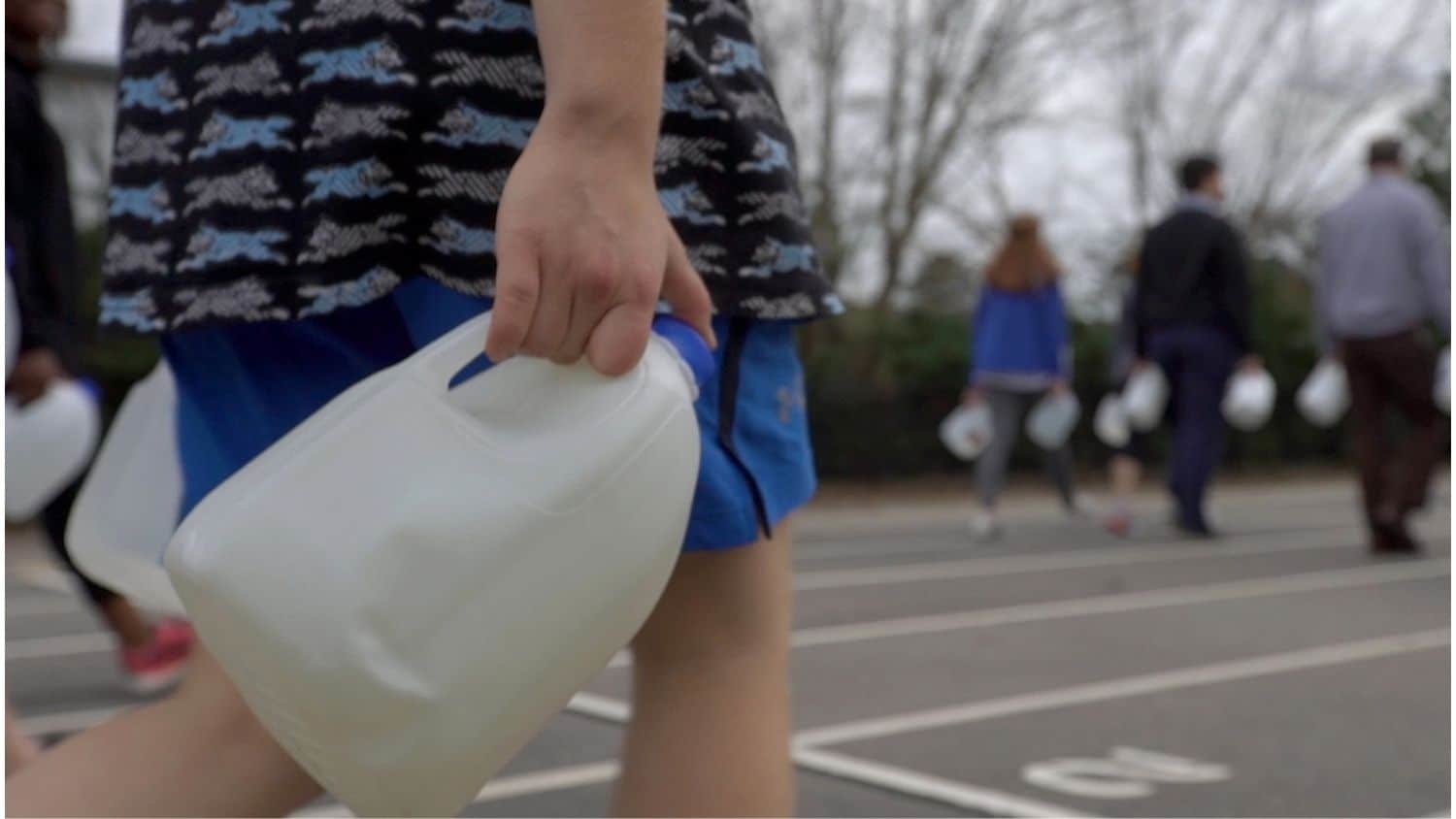 High school students carried water in a project designed to teach them about global water access.