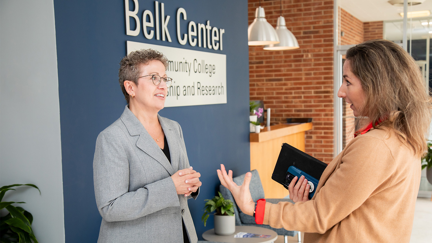Belk Center Executive Director Audrey Jaeger talking with another person at the Belk Center