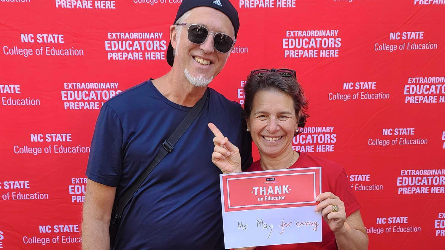 Dean Sztajn holding a Thank An Educator sign