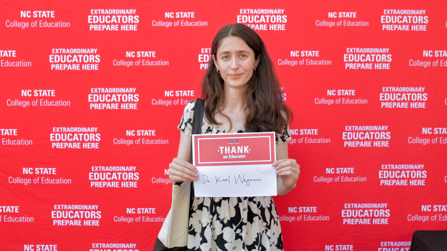A student and a Thank an Educator card