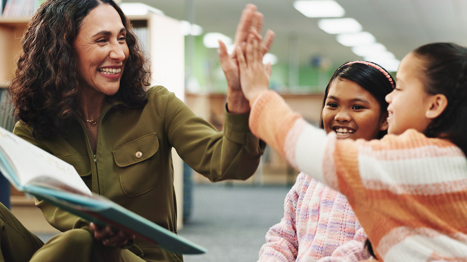 Teacher high fiving a student